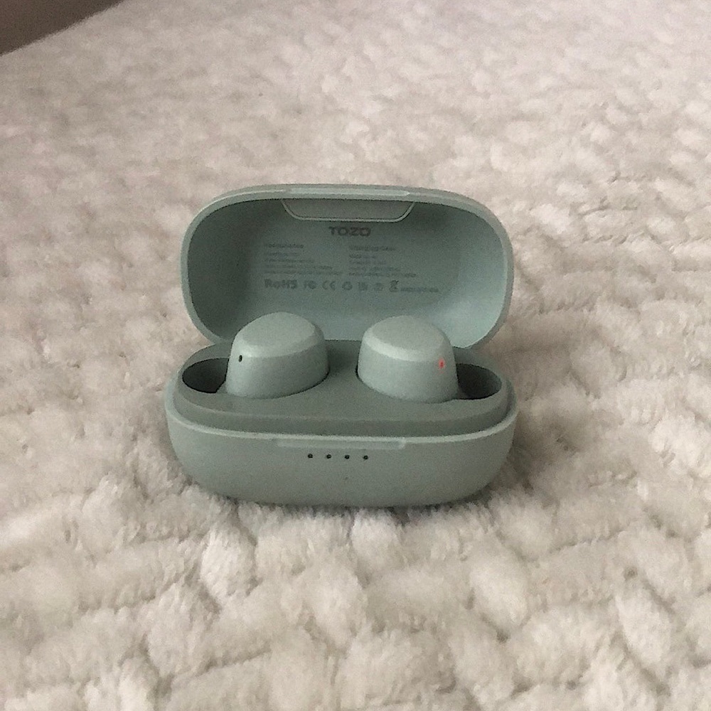 Emerald green Bluetooth headphones with charger and block
